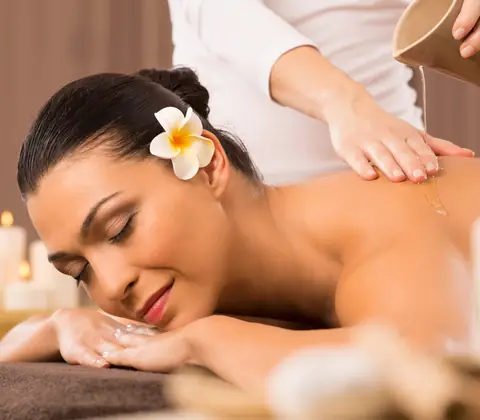 Woman receiving a back massage with oil