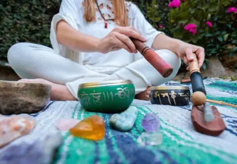 Woman playing a Tibetan singing bowl